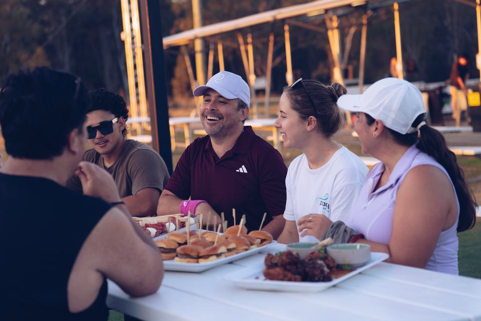 Players sharing food in the beer garden after a session